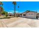 Attractive single-story home featuring an attached garage, a wide driveway, and mature landscaping at 1431 E San Juan Ave, Phoenix, AZ 85014