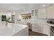 The kitchen has white cabinets, a large sink, a view to the outside, and stainless steel appliances at 1431 E San Juan Ave, Phoenix, AZ 85014