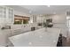 Modern kitchen with white cabinets, quartz countertops, stainless steel appliances, and large island at 1431 E San Juan Ave, Phoenix, AZ 85014