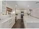 Bright kitchen features white cabinetry, quartz countertops, and stainless steel appliances at 1431 E San Juan Ave, Phoenix, AZ 85014