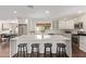 Spacious kitchen features white cabinets, a center island with seating, and stainless steel appliances at 1431 E San Juan Ave, Phoenix, AZ 85014