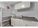 Functional laundry room equipped with ample storage cabinets and counter space for folding and sorting at 1431 E San Juan Ave, Phoenix, AZ 85014
