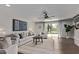 Bright living room with hardwood floors, modern furniture, a stylish ceiling fan, and a sliding glass door at 1431 E San Juan Ave, Phoenix, AZ 85014