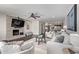 Bright and airy living room features a stone fireplace, dark floors, and an open concept layout at 1431 E San Juan Ave, Phoenix, AZ 85014
