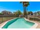 A pristine backyard pool, enclosed with a safety fence, surrounded by lush greenery, inviting for a refreshing swim at 1431 E San Juan Ave, Phoenix, AZ 85014