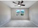 Inviting bedroom features carpet, a ceiling fan, and windows, offering a comfortable and well-lit space at 14770 W Voltaire St, Surprise, AZ 85379