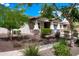 A quaint house with a covered porch, lush trees, and an inviting exterior view at 14770 W Voltaire St, Surprise, AZ 85379
