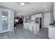 Open-concept kitchen with island, seating, and views into the living area at 14770 W Voltaire St, Surprise, AZ 85379