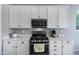 Modern kitchen has stainless steel appliances and white cabinets at 14770 W Voltaire St, Surprise, AZ 85379