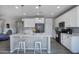 Spacious kitchen showcases a central island with modern appliances and ample cabinet space at 14770 W Voltaire St, Surprise, AZ 85379