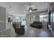 Open-concept living room with wood-look tile floors and plenty of natural light at 14770 W Voltaire St, Surprise, AZ 85379