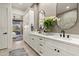 Stylish bathroom with dual sinks, quartz countertop, and backyard view at 15240 N Clubgate Dr # 137, Scottsdale, AZ 85254
