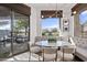 Bright breakfast nook with a built-in bench, round table, and sliding glass doors leading to the patio with golf course view at 15240 N Clubgate Dr # 137, Scottsdale, AZ 85254
