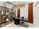 Modern home office featuring custom shelving, a sleek desk, and stylish light fixture with neutral color palette at 15240 N Clubgate Dr # 137, Scottsdale, AZ 85254