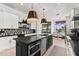 Gourmet kitchen featuring a center island with seating, stainless steel appliances, and adjacent breakfast nook at 15240 N Clubgate Dr # 137, Scottsdale, AZ 85254