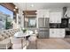 Modern kitchen boasts stainless steel appliances, white cabinets, and a stylish breakfast nook with a tufted bench at 15240 N Clubgate Dr # 137, Scottsdale, AZ 85254