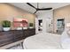 Well-lit main bedroom features modern furniture, a large TV, and easy access to the en-suite bathroom at 15240 N Clubgate Dr # 137, Scottsdale, AZ 85254