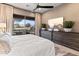 Spacious main bedroom offers a ceiling fan, patio access, and contemporary furniture at 15240 N Clubgate Dr # 137, Scottsdale, AZ 85254