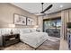 Bright main bedroom featuring neutral tones, a ceiling fan, and sliding glass doors to a private patio at 15240 N Clubgate Dr # 137, Scottsdale, AZ 85254