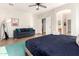 Comfortable bedroom featuring a ceiling fan, a blue couch, and a king-size bed at 15432 W Yucatan Dr, Surprise, AZ 85379