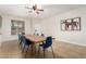 Inviting dining space with tile flooring, a generous wooden table, and tasteful wall decor at 15432 W Yucatan Dr, Surprise, AZ 85379