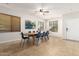 Bright dining area featuring neutral walls, tile flooring and a sizable wooden dining table at 15432 W Yucatan Dr, Surprise, AZ 85379