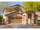 Inviting home showcasing a two-car garage and covered front entry, framed by desert landscaping at 15432 W Yucatan Dr, Surprise, AZ 85379