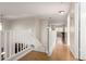 View from the top of the stairs looking down the hallway with wood floors at 15432 W Yucatan Dr, Surprise, AZ 85379