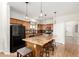Spacious kitchen featuring tile countertops, dark appliances, and a large central island at 15432 W Yucatan Dr, Surprise, AZ 85379