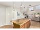 View of the island in the kitchen looking into the spacious living area at 15432 W Yucatan Dr, Surprise, AZ 85379