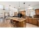 The kitchen overlooks the open-concept living area, featuring a breakfast bar and black appliances at 15432 W Yucatan Dr, Surprise, AZ 85379