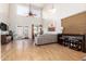 Bright living room features high ceilings, a ceiling fan, and a large couch at 15432 W Yucatan Dr, Surprise, AZ 85379