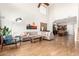 Open-concept living area with hardwood floors, plush seating, and a seamless flow to the kitchen at 15432 W Yucatan Dr, Surprise, AZ 85379