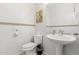 This is a well-lit and compact powder room with a white pedestal sink at 15432 W Yucatan Dr, Surprise, AZ 85379