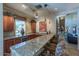 A well-appointed bar area features granite countertops, wooden cabinets, and comfortable seating at 16013 S Desert Foothills Pkwy # 2130, Phoenix, AZ 85048