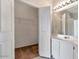 Bathroom showcasing a large vanity with double sinks, a mirror, and a walk-in closet at 16013 S Desert Foothills Pkwy # 2130, Phoenix, AZ 85048