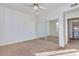 Bedroom with a ceiling fan, mirrored closet doors, and views into the kitchen at 16013 S Desert Foothills Pkwy # 2130, Phoenix, AZ 85048