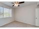 Bedroom highlighting a ceiling fan, bright window, and neutral carpeting at 16013 S Desert Foothills Pkwy # 2130, Phoenix, AZ 85048