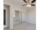 Bedroom featuring mirrored closet doors, a ceiling fan, and neutral-colored carpeting at 16013 S Desert Foothills Pkwy # 2130, Phoenix, AZ 85048