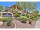 Attractive condominium exterior with lush landscaping and community sign at 16013 S Desert Foothills Pkwy # 2130, Phoenix, AZ 85048