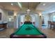 Bright game room features a billiard table with a stylish pendant light fixture and comfortable seating at 16013 S Desert Foothills Pkwy # 2130, Phoenix, AZ 85048