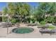 Outdoor hot tub with surrounding lounge chairs, lush landscaping, and beautiful community at 16013 S Desert Foothills Pkwy # 2130, Phoenix, AZ 85048