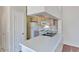 Bright kitchen boasts light wood cabinets, white appliances, and a breakfast bar at 16013 S Desert Foothills Pkwy # 2130, Phoenix, AZ 85048