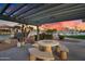 A covered outdoor kitchen with grill, table, and views of the nearby water at 16013 S Desert Foothills Pkwy # 2130, Phoenix, AZ 85048