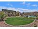 Relaxing community pool area with well-maintained lawn, shaded pergola and lounge chairs at 16013 S Desert Foothills Pkwy # 2130, Phoenix, AZ 85048