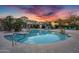 A view of the community pool with lounge chairs and clear blue water at 16013 S Desert Foothills Pkwy # 2130, Phoenix, AZ 85048