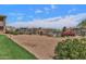 Community sand volleyball court surrounded by lush landscaping and residential buildings at 16013 S Desert Foothills Pkwy # 2130, Phoenix, AZ 85048