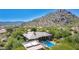 Expansive estate featuring a sparkling pool and lush landscaping, surrounded by the natural beauty of the desert at 16469 N 113Th Way, Scottsdale, AZ 85255