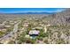 An aerial view captures an estate home nestled amidst lush desert landscaping, complete with a sparkling pool at 16469 N 113Th Way, Scottsdale, AZ 85255