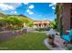 Spacious backyard with manicured lawn, stone patio, and views of the mountains at 16469 N 113Th Way, Scottsdale, AZ 85255